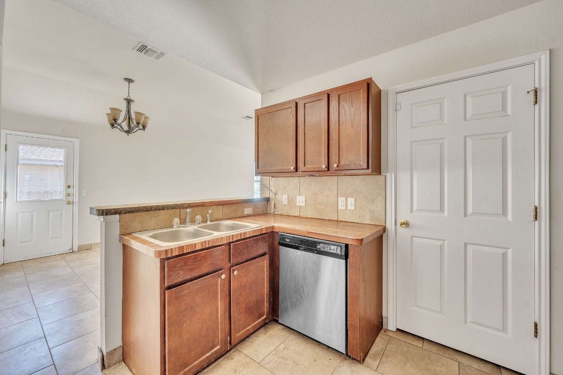 1007 Trail Driver Cove Georgetown, TX 78626 - Photo 3 of 16 a utility room with cabinets washer and dryer