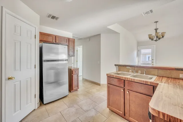 a kitchen with stainless steel appliances granite countertop a refrigerator and a sink
