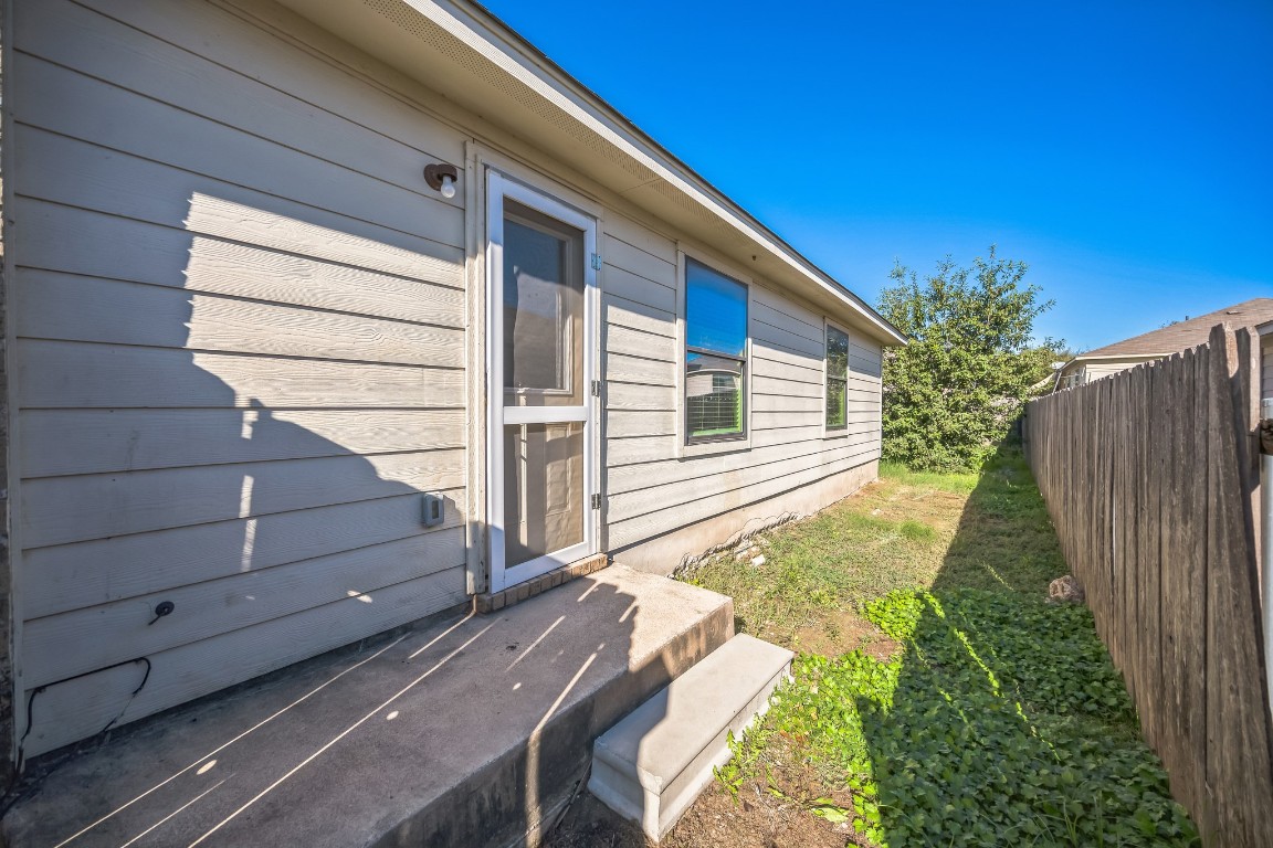 1007 Trail Driver Cove Georgetown, TX 78626 - Photo 7 of 16 a view of a backyard with wooden fence and large trees