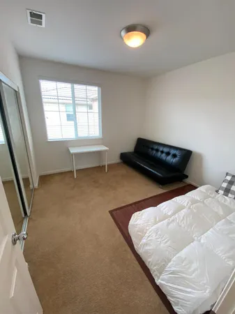 a spacious bathroom with a double vanity sink mirror and bathtub