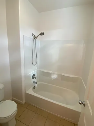 a bedroom with bed and a window