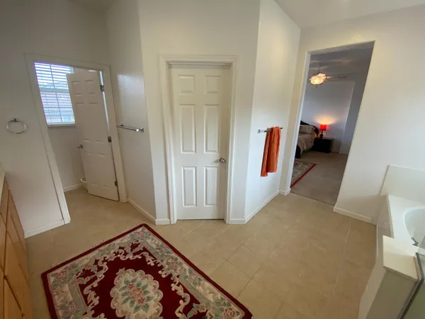 a bathroom with a toilet a sink and a window