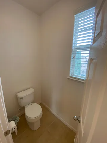 a bedroom with a bed and a bookshelf with the shoe rack