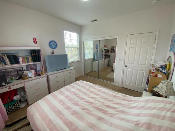 a bedroom with a bed and a dresser