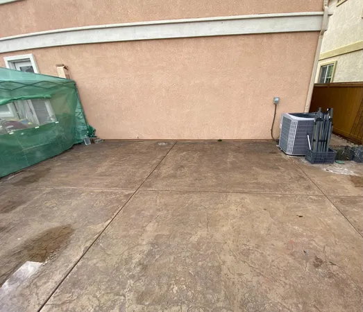a view of a porch with furniture and flowers
