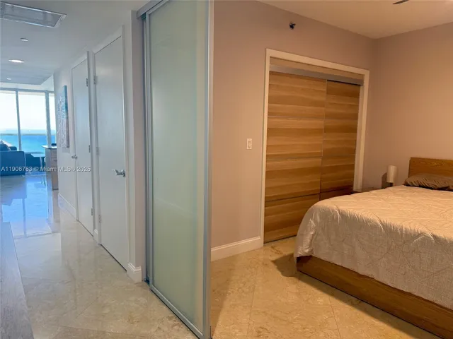 a bedroom with a bed and a table