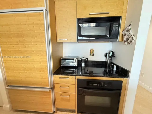 a kitchen with stainless steel appliances a stove and a microwave