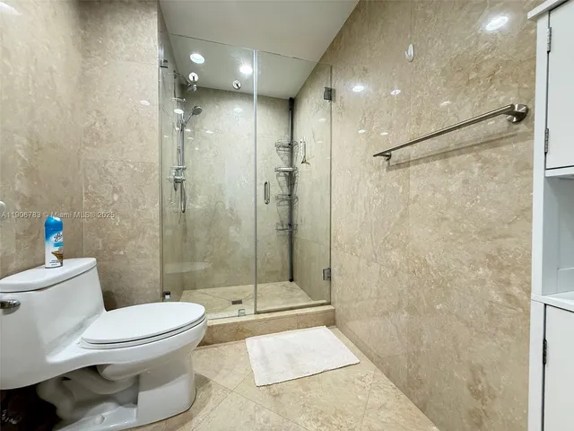 a bathroom with a toilet and shower