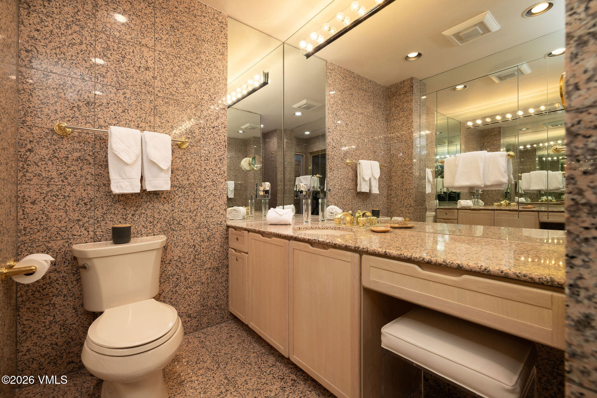200 Vail Road, Unit 799 Vail, CO 81657 - Photo 16 of 32 a bathroom with a granite countertop toilet sink and mirror