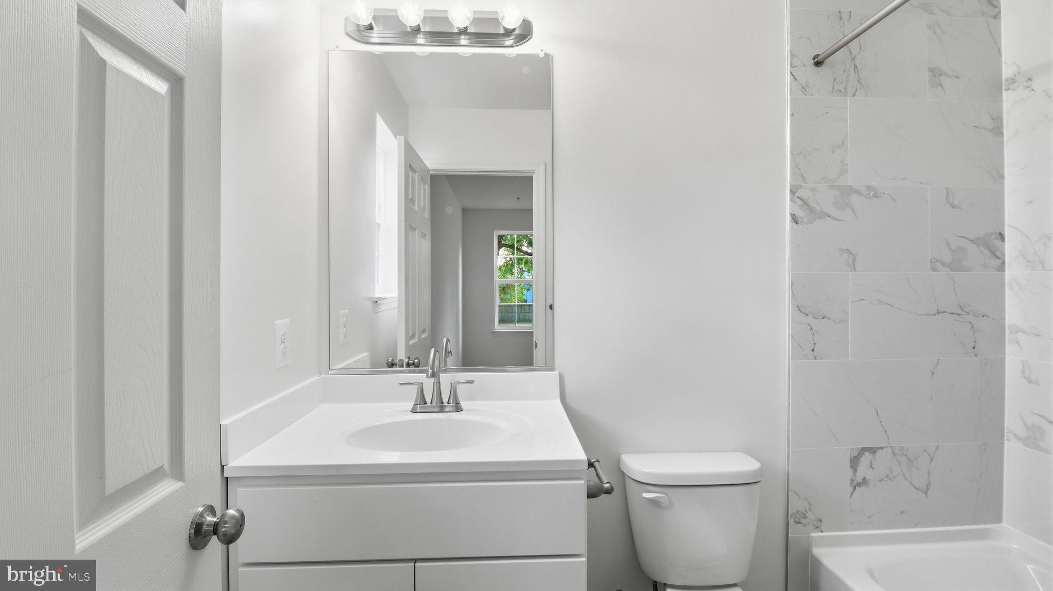 7349 Hughes Avenue Sparrows Point, MD 21219 - Photo 16 of 38 a bathroom with a sink toilet and shower