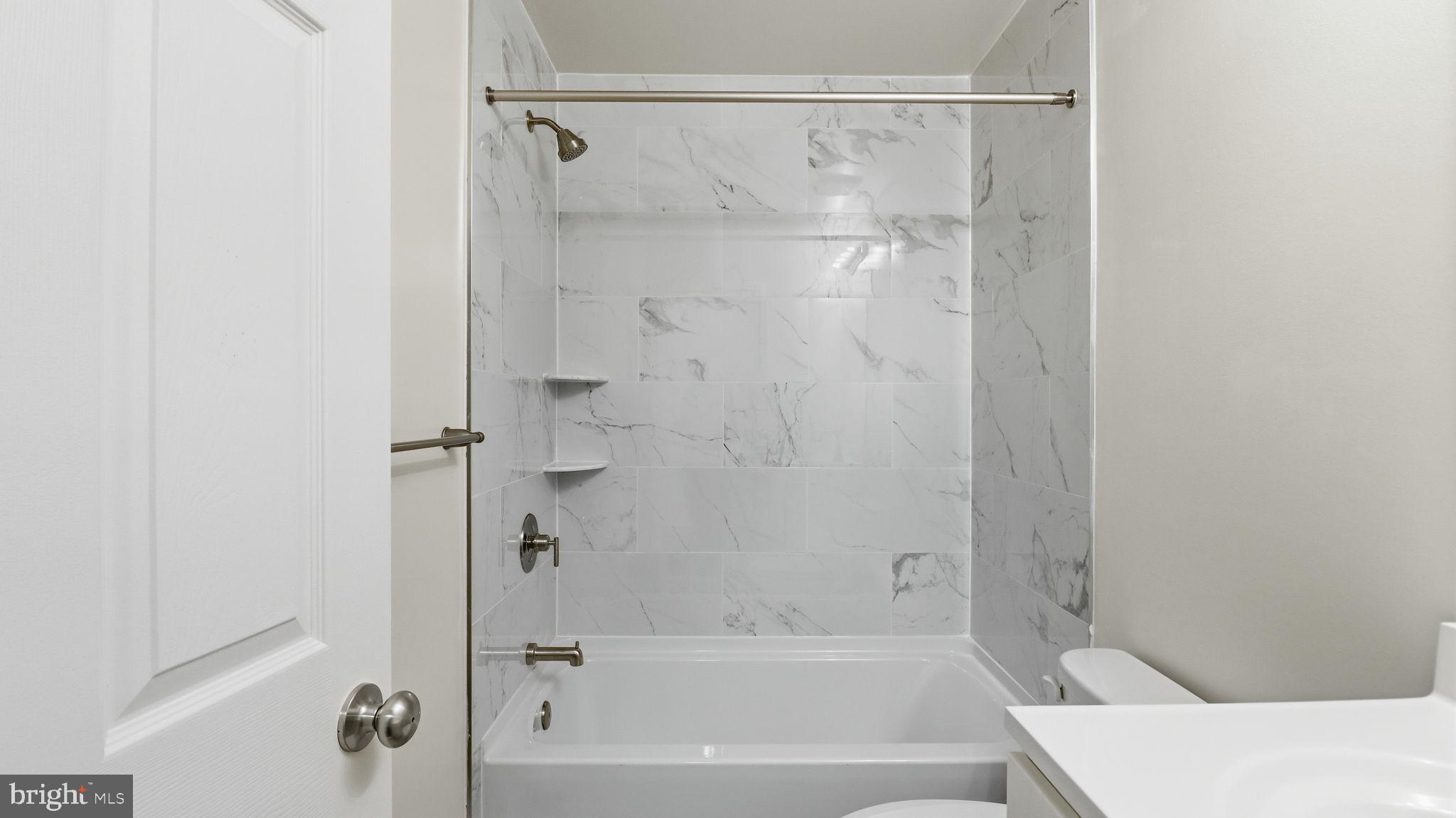 7349 Hughes Avenue Sparrows Point, MD 21219 - Photo 23 of 38 a bathroom with a bathtub and a shower