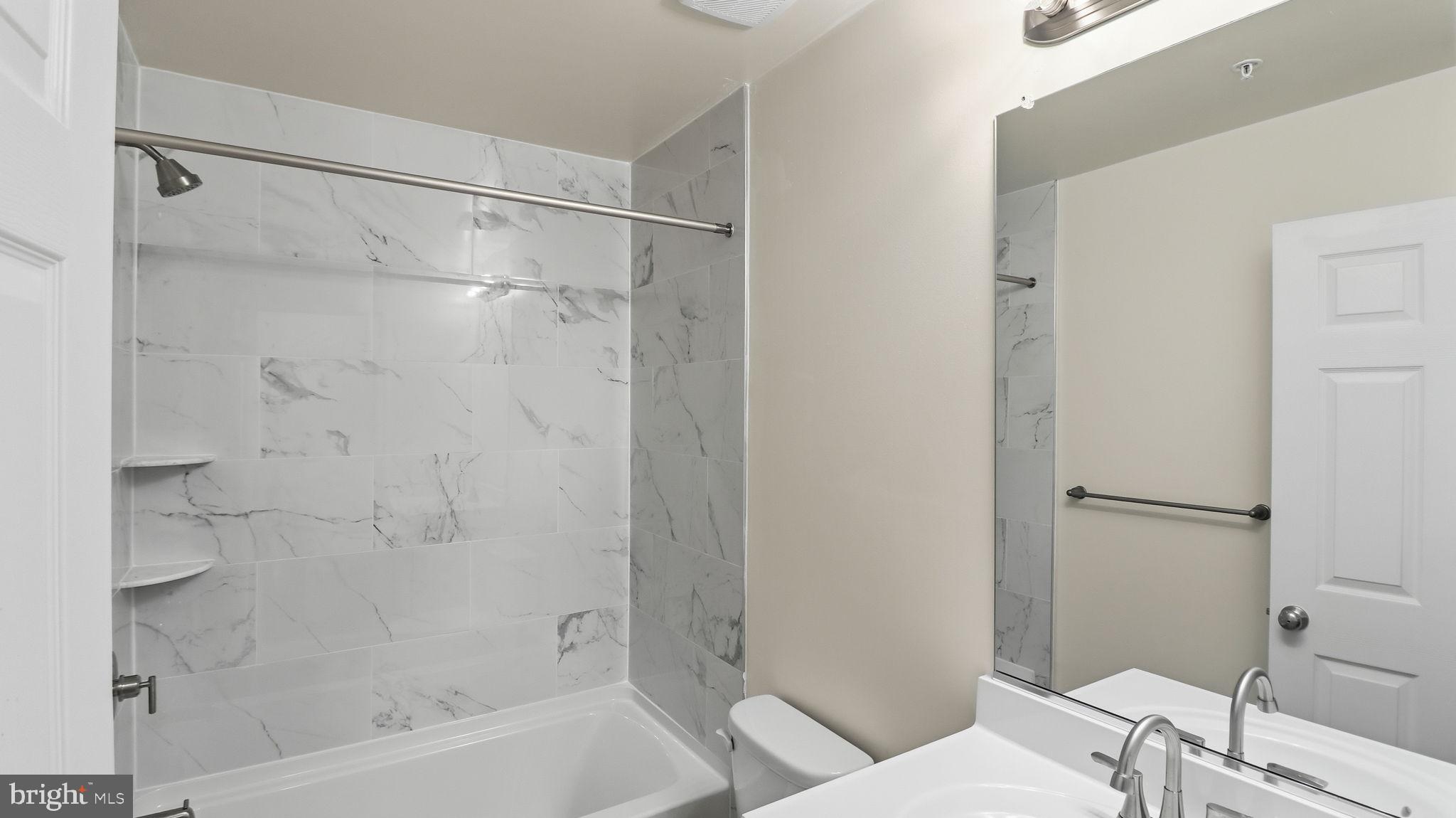 7349 Hughes Avenue Sparrows Point, MD 21219 - Photo 24 of 38 a bathroom with a bathtub and a shower