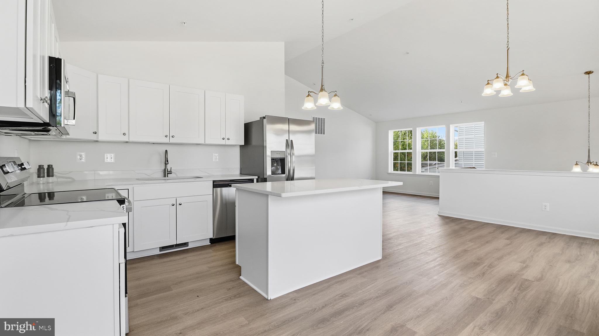 7349 Hughes Avenue Sparrows Point, MD 21219 - Photo 28 of 38 a kitchen with cabinets wooden floor and a fireplace
