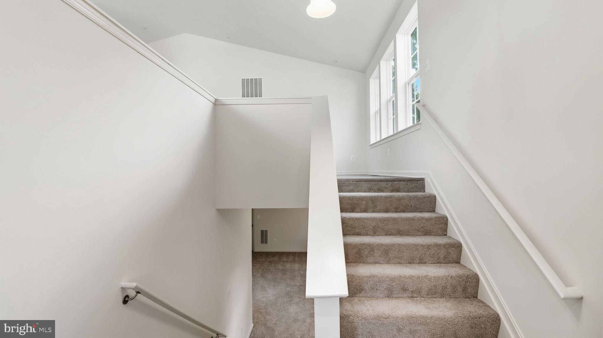 7349 Hughes Avenue Sparrows Point, MD 21219 - Photo 35 of 38 a view of staircase with white walls and white walls