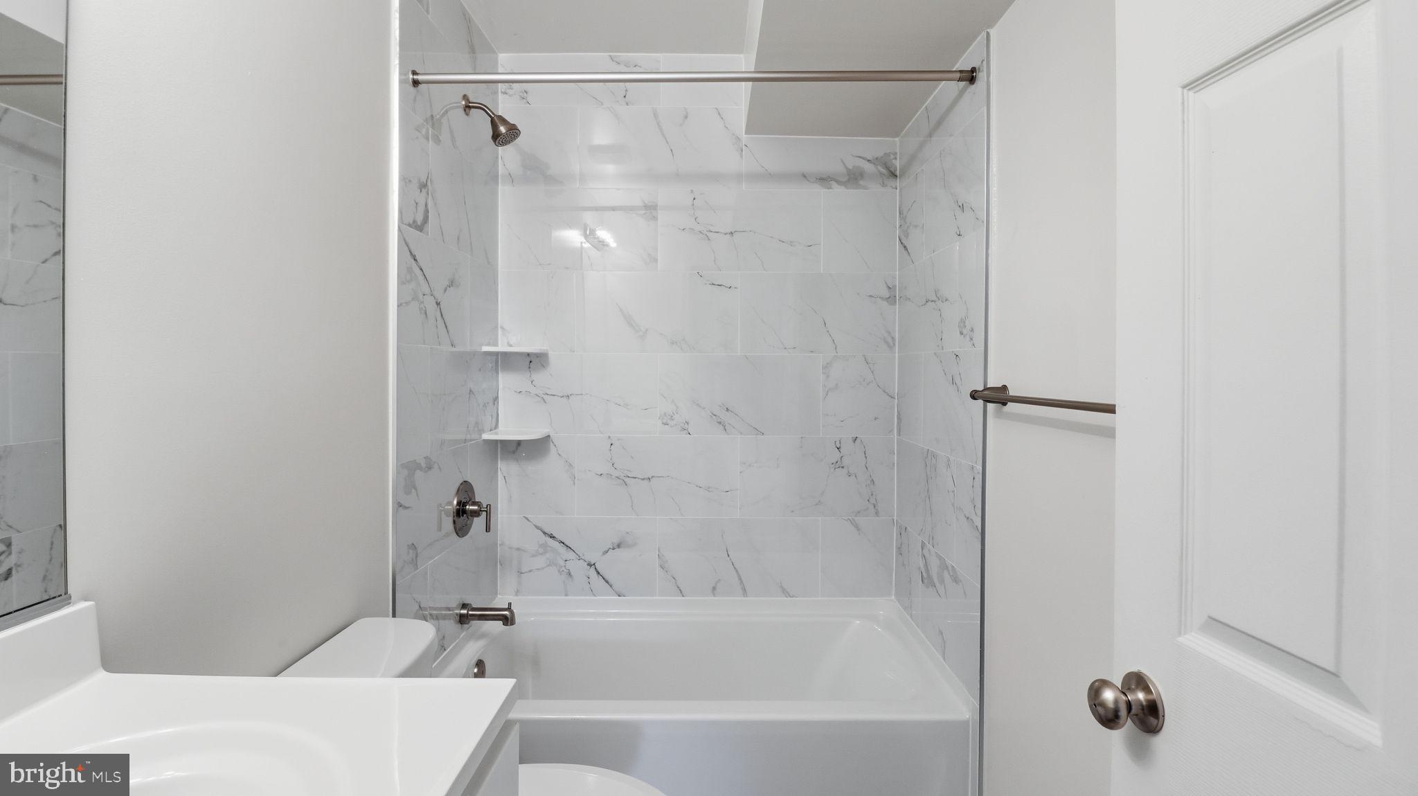 7349 Hughes Avenue Sparrows Point, MD 21219 - Photo 7 of 38 a bathroom with a bathtub and a shower