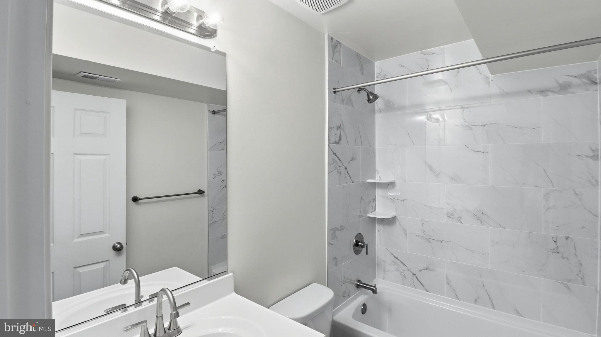 7349 Hughes Avenue Sparrows Point, MD 21219 - Photo 8 of 38 a bathroom with a bathtub and a shower