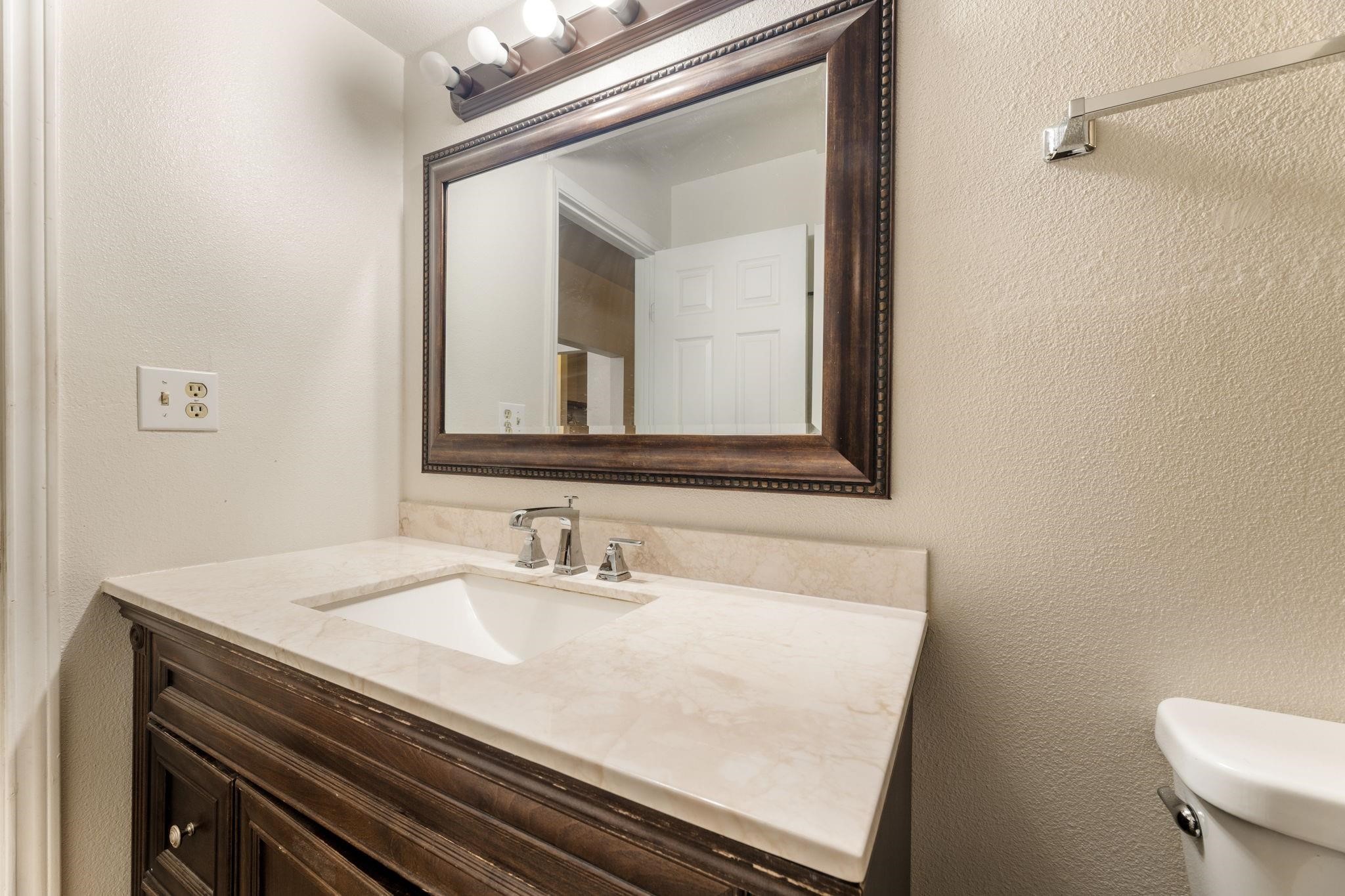 3606 Balmorhea Avenue Houston, TX 77039 - Photo 13 of 21 a bathroom with a sink a toilet and mirror