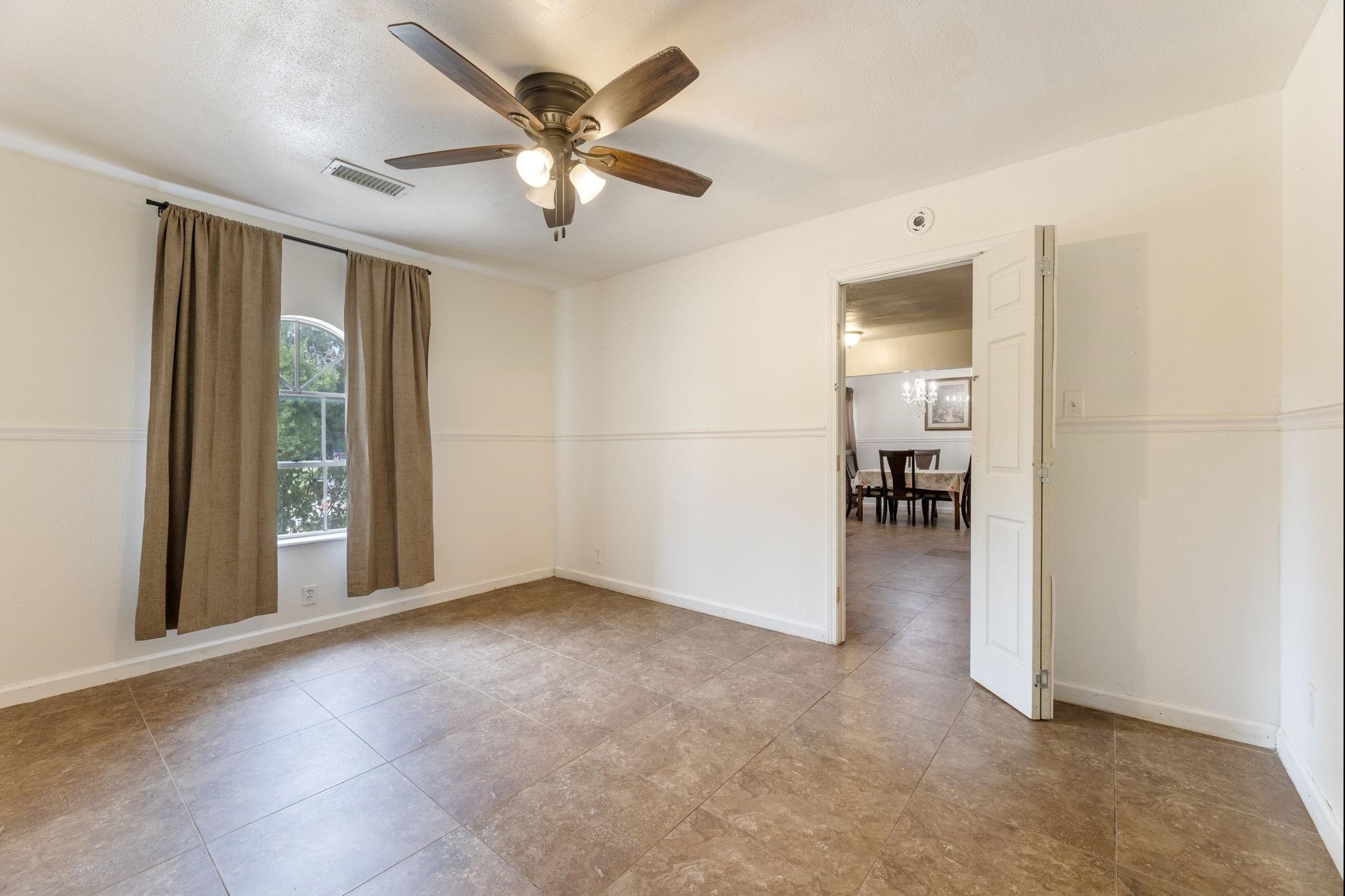 3606 Balmorhea Avenue Houston, TX 77039 - Photo 14 of 21 an empty room with chandelier fan and windows