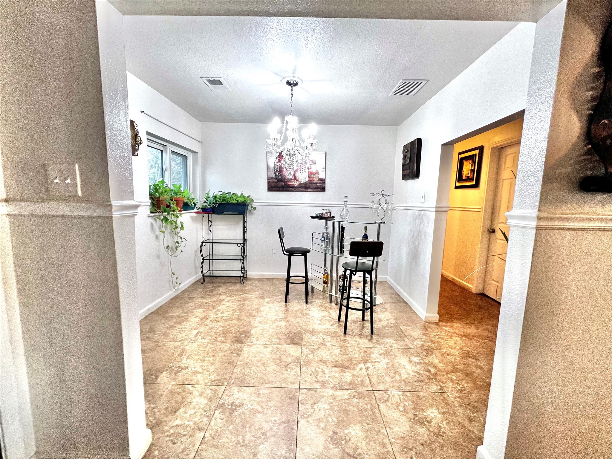 3606 Balmorhea Avenue Houston, TX 77039 - Photo 5 of 21 a view of a dining room with furniture and a chandelier