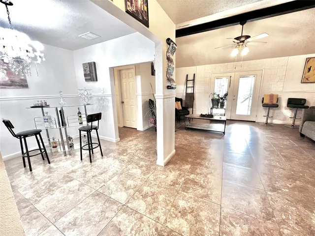 a view of a livingroom with furniture and a ceiling fan