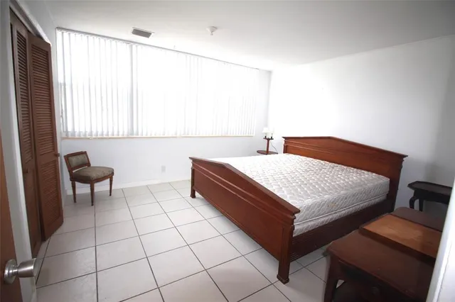 a bedroom with a bed and a table in it