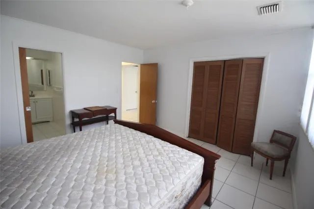 a bedroom with a bed and chair