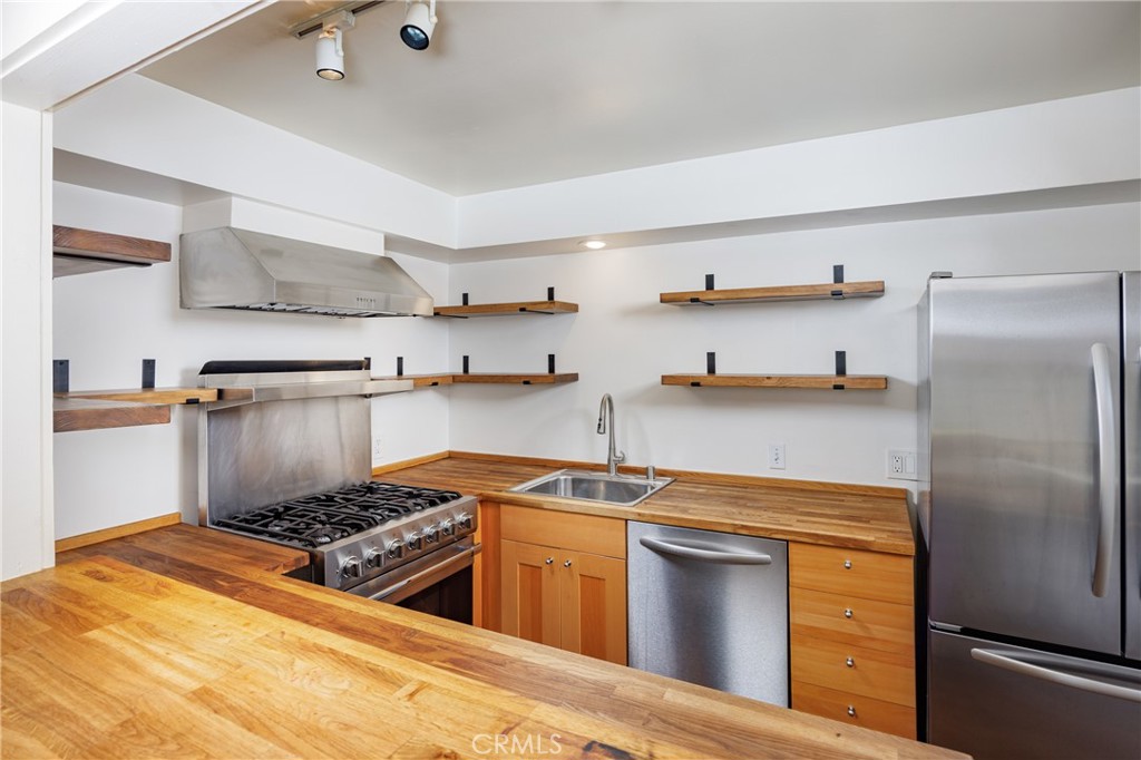 351 Hazel Drive Corona del Mar, CA 92625 - Photo 12 of 58 a kitchen with stainless steel appliances granite countertop a stove a refrigerator and a sink