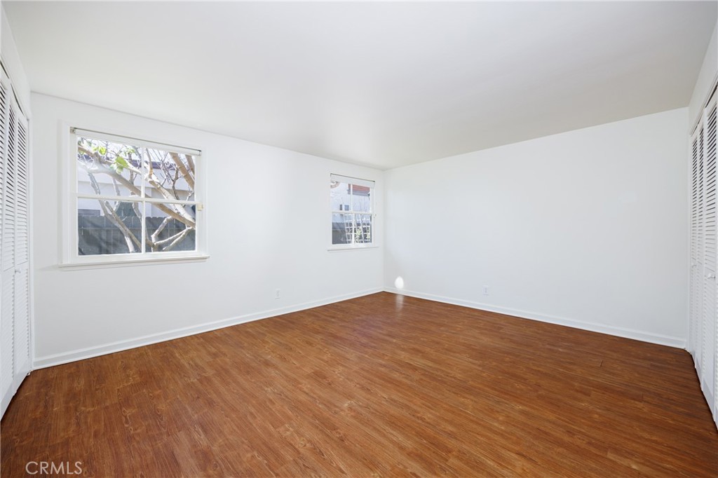 351 Hazel Drive Corona del Mar, CA 92625 - Photo 15 of 58 a view of an empty room with wooden floor and a window