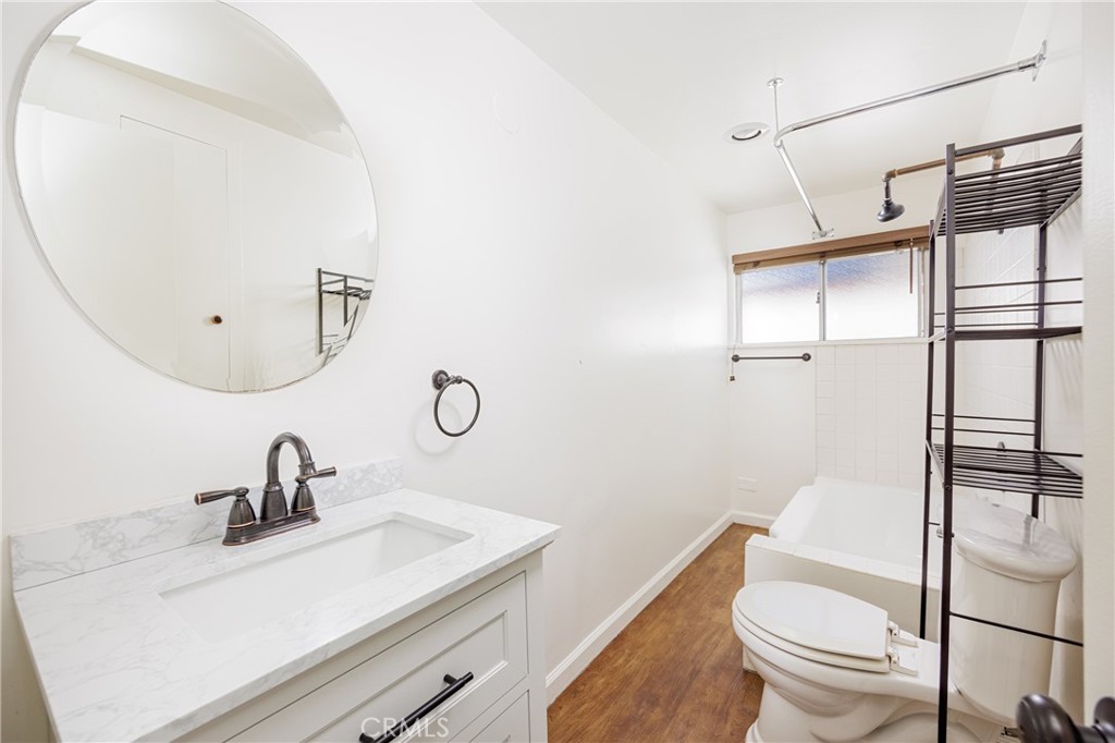 351 Hazel Drive Corona del Mar, CA 92625 - Photo 17 of 58 a bathroom with a sink a toilet and a mirror