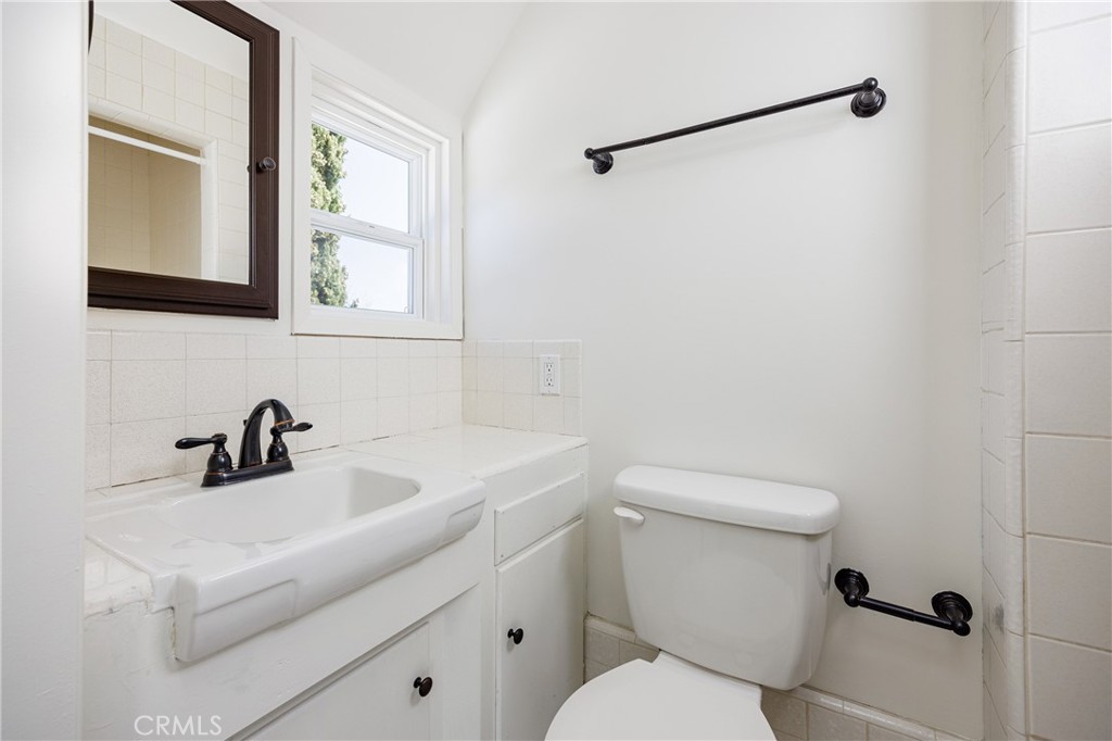 351 Hazel Drive Corona del Mar, CA 92625 - Photo 20 of 58 a bathroom with a sink mirror and toilet