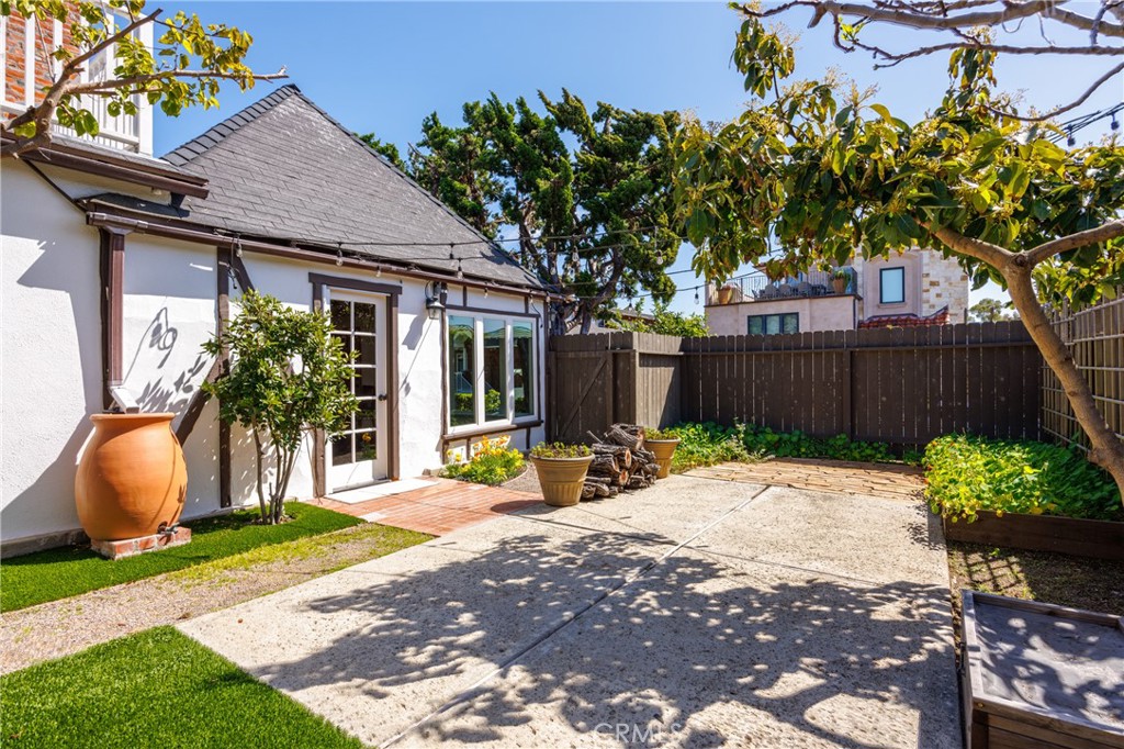 351 Hazel Drive Corona del Mar, CA 92625 - Photo 29 of 58 a backyard of a house with table and chairs with a small yard
