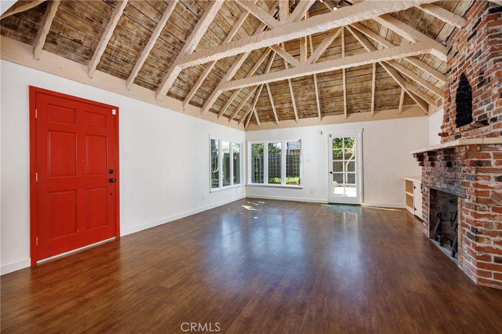 351 Hazel Drive Corona del Mar, CA 92625 - Photo 4 of 58 an empty room with wooden floor and fireplace