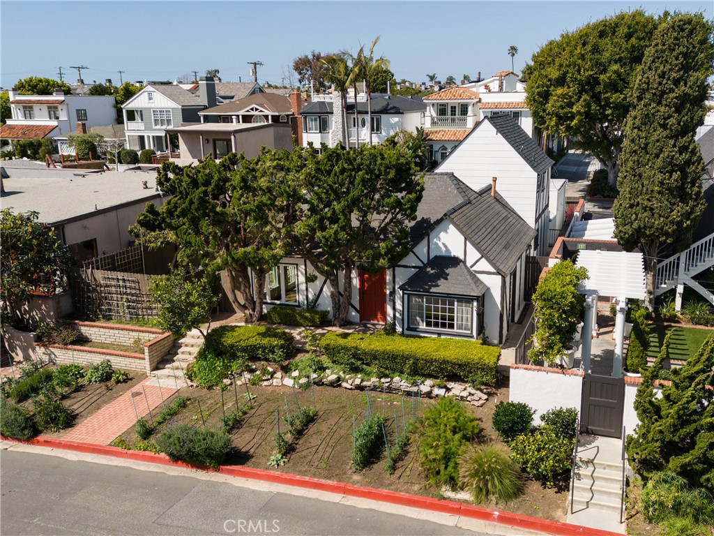 351 Hazel Drive Corona del Mar, CA 92625 - Photo 49 of 58 a view of a white house with a yard and plants