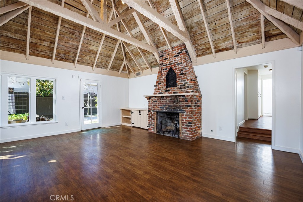 351 Hazel Drive Corona del Mar, CA 92625 - Photo 5 of 58 an empty room with wooden floor and fireplace