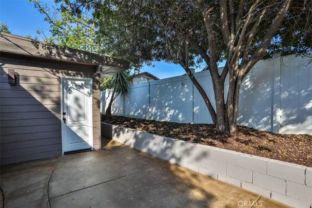 a view of a lake with a table and chairs under an umbrella