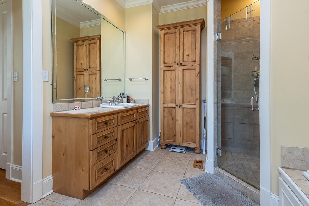 1915 Teague Store Road Somerville, TN 38068 - Photo 31 of 38 Bathroom featuring a wood-finish vanity with an integrated sink, a large mirror, and a tiled countertop
