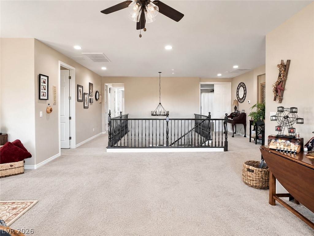 9724 University Ridge Avenue Las Vegas, NV 89149 - Photo 46 of 61 A spacious upper-level landing with plush carpeting and natural light provides a comfortable transition area.
