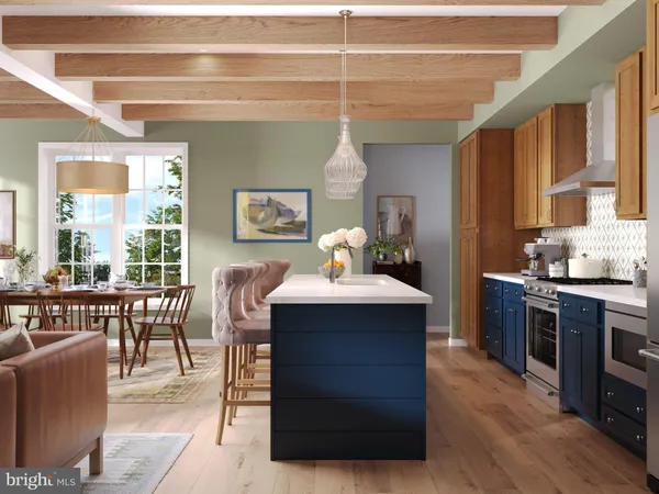 a kitchen with kitchen island a stove a sink a dining table and chairs