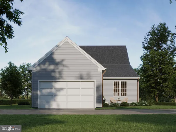 a front view of a house with a garden and yard