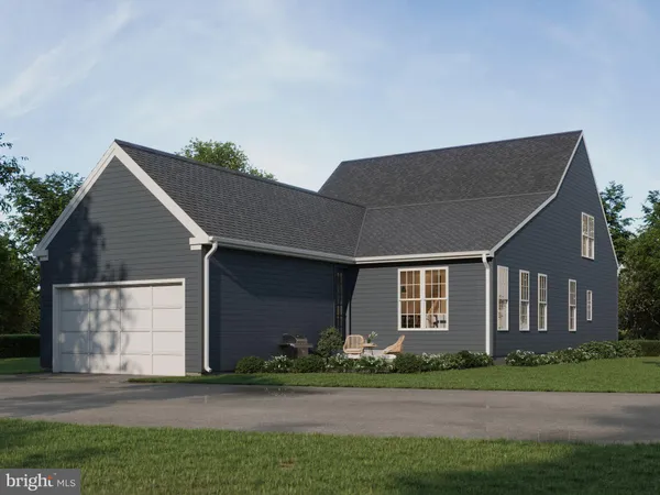 a front view of a house with a garden and yard