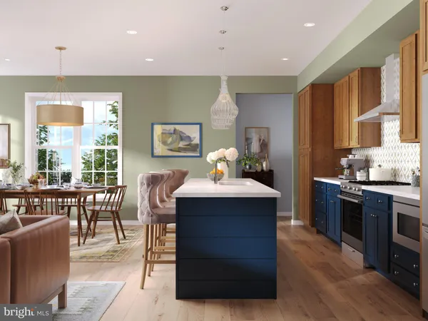 a kitchen with kitchen island a stove a sink a dining table and chairs