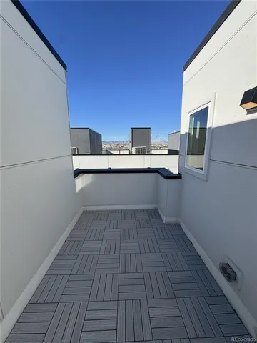 a kitchen with a sink and wooden floor