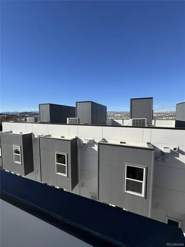 a view of a kitchen with stainless steel appliances a stove top oven