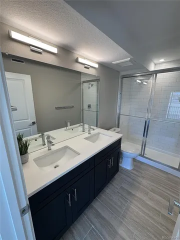 a bathroom with a double vanity sink and mirror