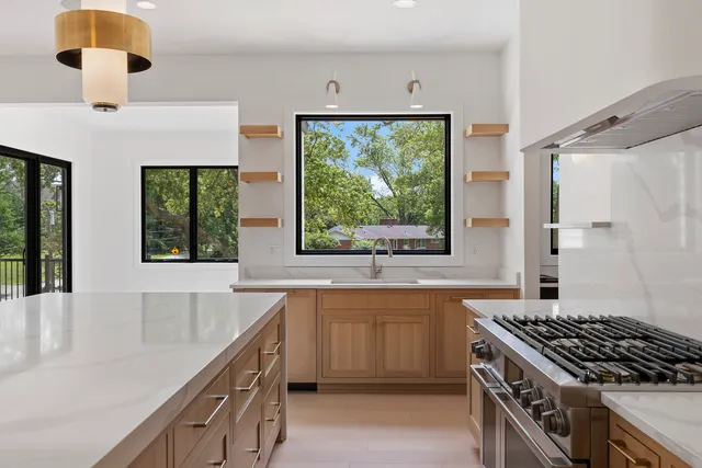 a kitchen with a sink and large window