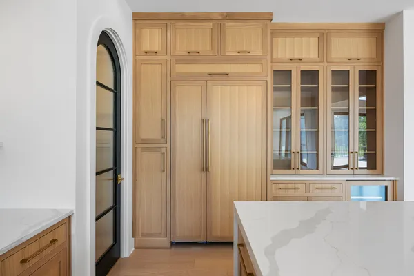 a view of a kitchen with white cabinets