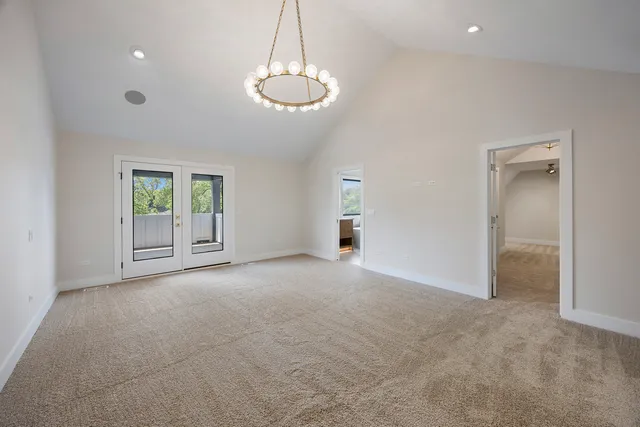 a spacious bathroom with a double vanity sink a large mirror and a shower