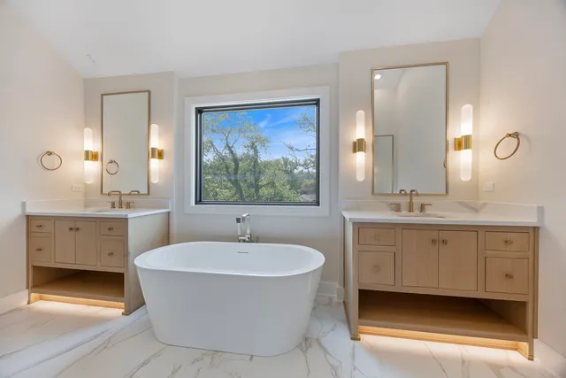 a white bath tub sitting next to a white sink
