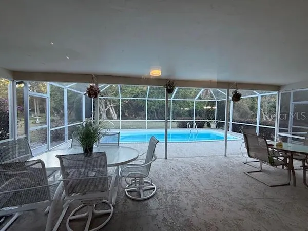 a view of a chairs and table in patio