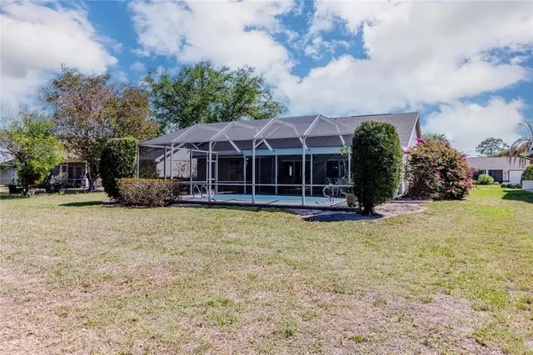 a view of a house with backyard and sitting area